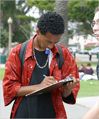 Students solicit information from high school students at the Santa Monica Pier.