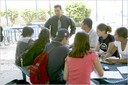 Students look on and take notes during an interview with a school official at South High School. 