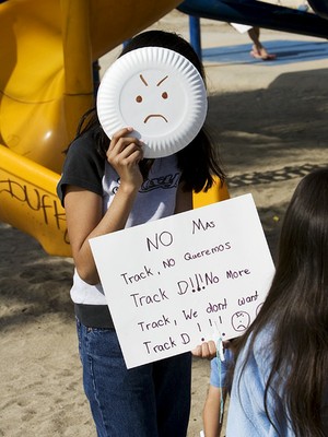 Child with plate mask and sign